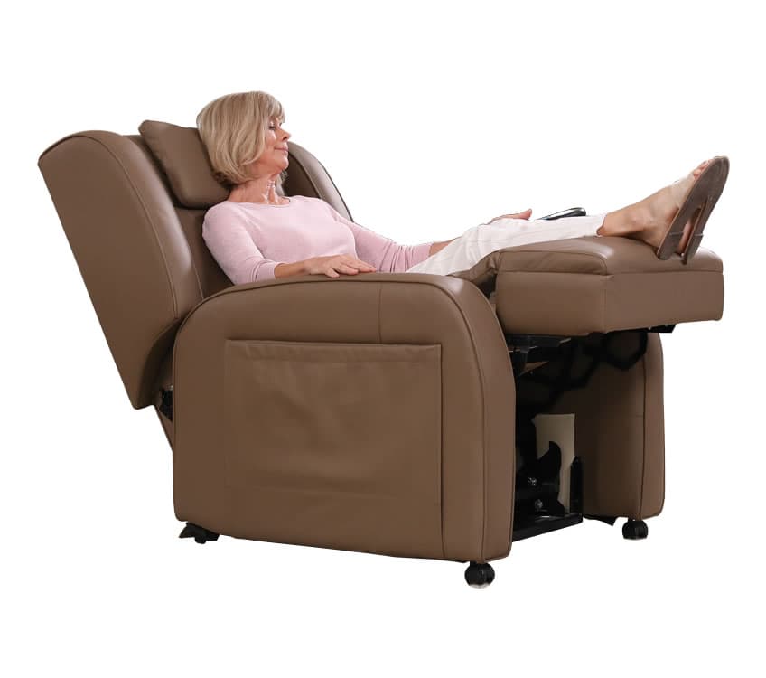 A woman relaxing in a reclined massage chair in her lounge room